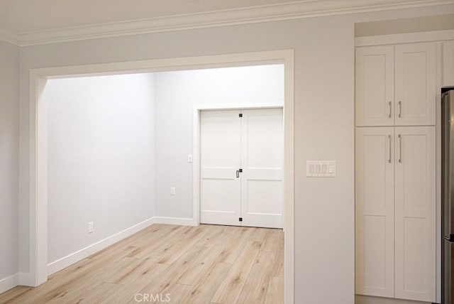 unfurnished bedroom with crown molding and light hardwood / wood-style flooring