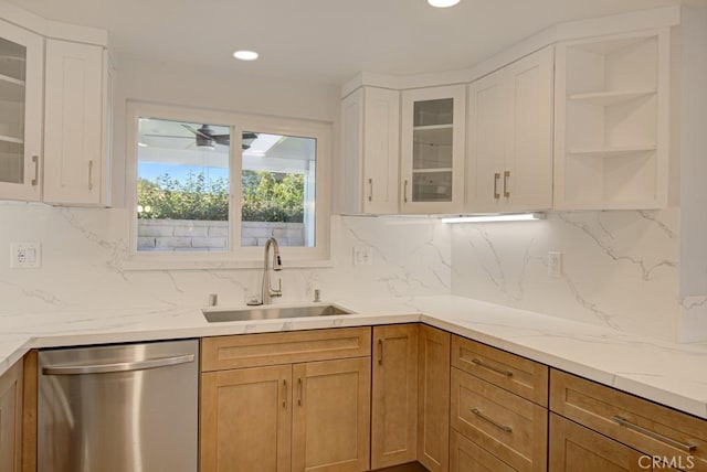 kitchen featuring white cabinetry, tasteful backsplash, sink, ceiling fan, and stainless steel dishwasher