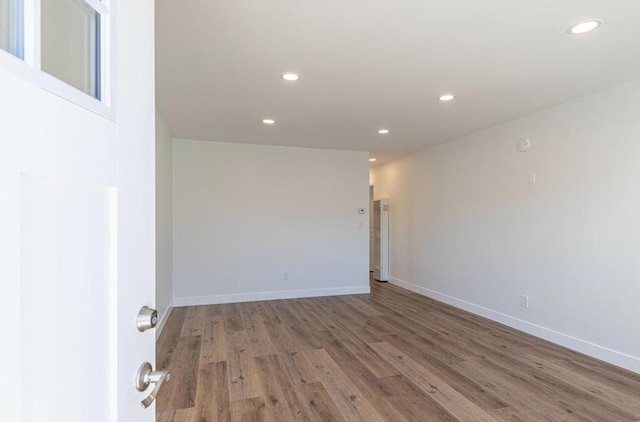 empty room with hardwood / wood-style flooring