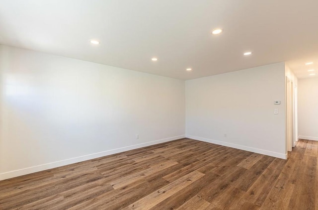 empty room with dark hardwood / wood-style flooring