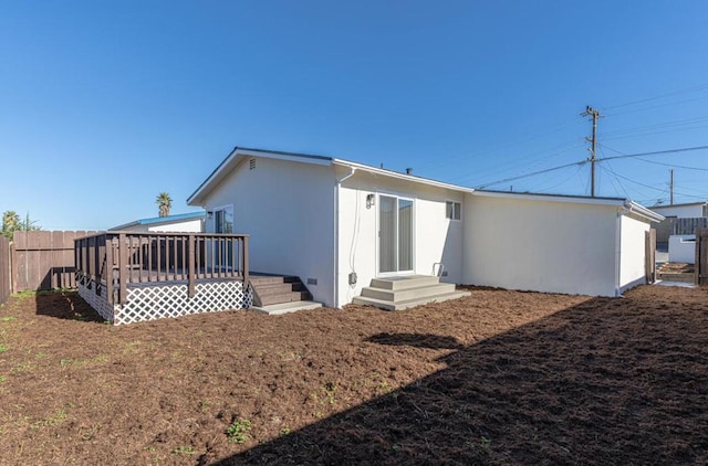 back of property featuring a wooden deck