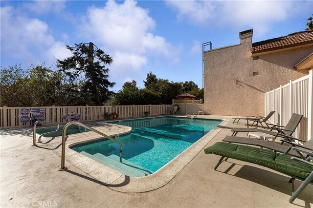 view of swimming pool featuring a patio area