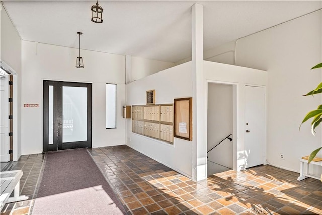 foyer entrance featuring mail boxes and a high ceiling