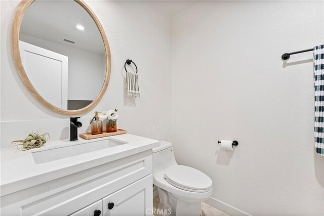 bathroom featuring toilet and vanity