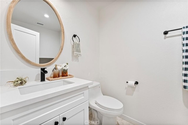 bathroom featuring toilet and vanity