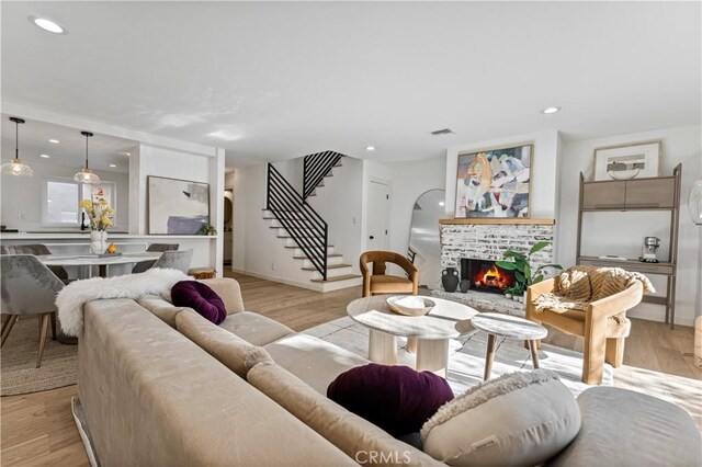 living room with a fireplace and light hardwood / wood-style flooring