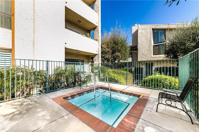 view of pool featuring a hot tub