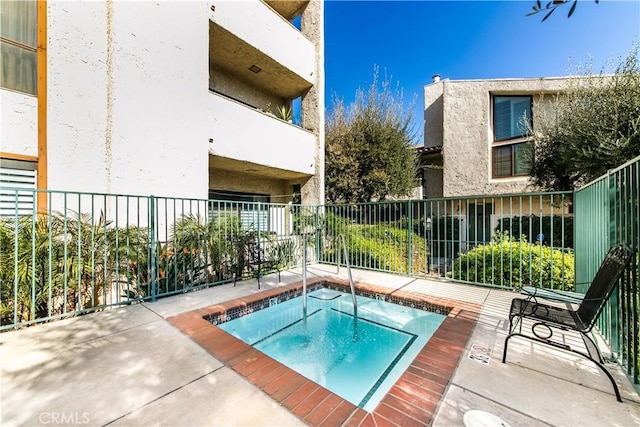 view of swimming pool featuring a community hot tub