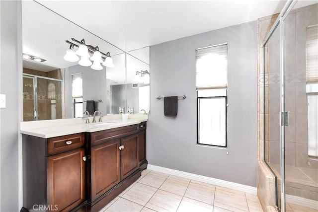 bathroom featuring vanity, plenty of natural light, a shower with door, and tile patterned flooring