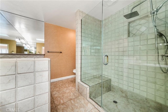 bathroom with a shower with shower door, tile patterned flooring, and toilet