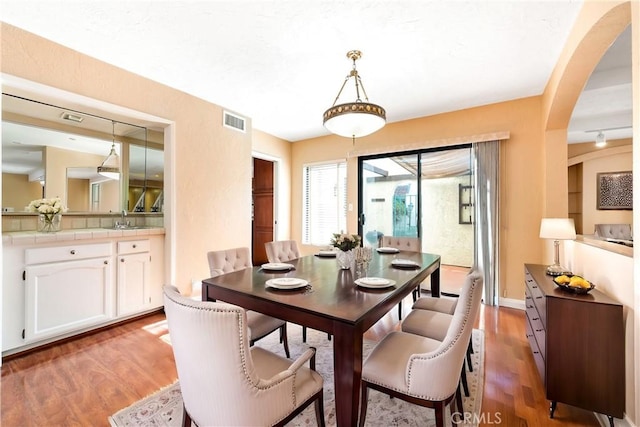 dining room with light hardwood / wood-style floors and sink