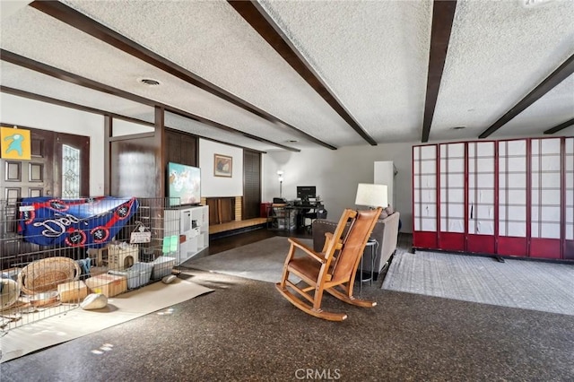 interior space with beamed ceiling and a textured ceiling