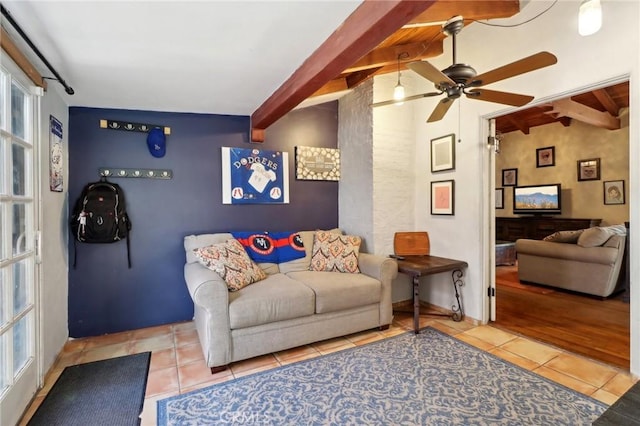 tiled living room featuring beam ceiling and ceiling fan