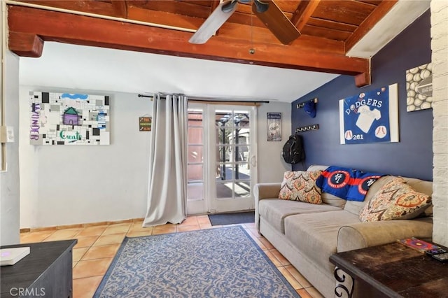 living room with ceiling fan, light tile patterned floors, wooden ceiling, and beamed ceiling