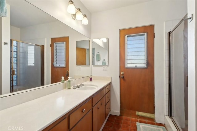 bathroom with walk in shower, vanity, and tile patterned floors