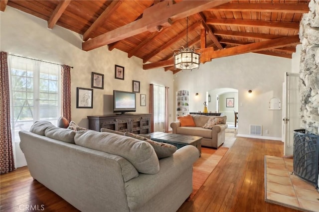 living room featuring light hardwood / wood-style floors, high vaulted ceiling, and a notable chandelier