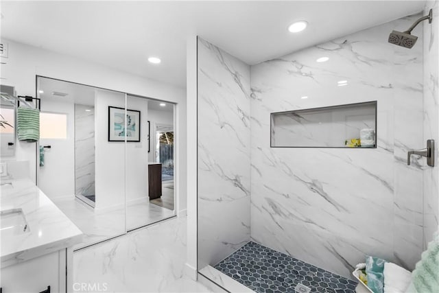 bathroom featuring vanity and tiled shower