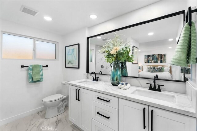 bathroom with toilet and vanity