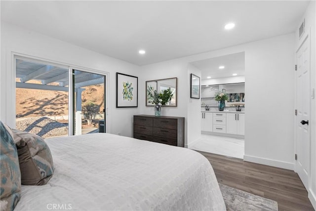 bedroom with sink, hardwood / wood-style floors, and access to outside