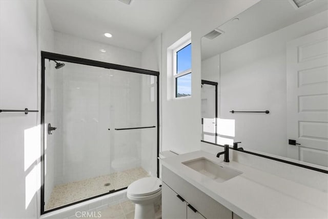 bathroom featuring vanity, toilet, and walk in shower