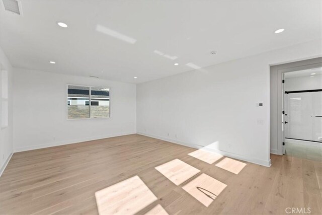 spare room featuring light hardwood / wood-style flooring