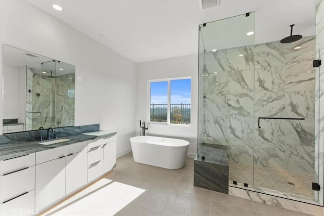 bathroom with tile patterned floors, vanity, and plus walk in shower