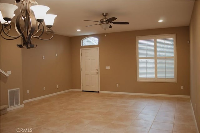 interior space featuring ceiling fan with notable chandelier and plenty of natural light