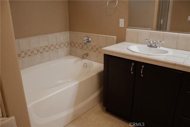 bathroom featuring tile patterned floors, a tub to relax in, and vanity