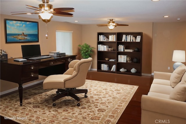 office area with ceiling fan and dark hardwood / wood-style floors