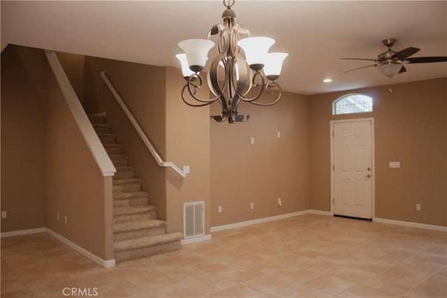 interior space with ceiling fan with notable chandelier