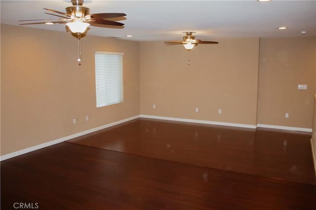 empty room with ceiling fan and wood-type flooring