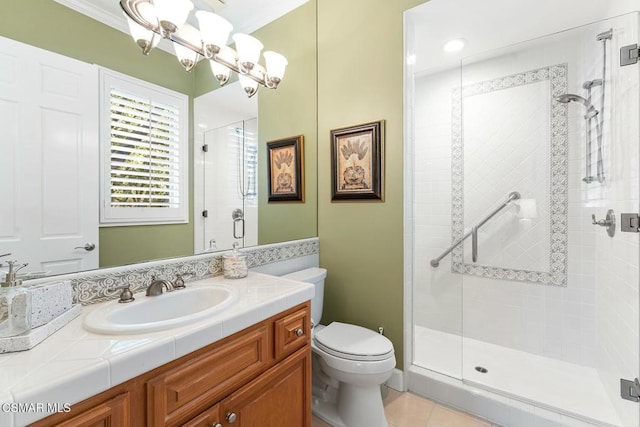 bathroom with tile patterned floors, ornamental molding, toilet, a shower with shower door, and vanity