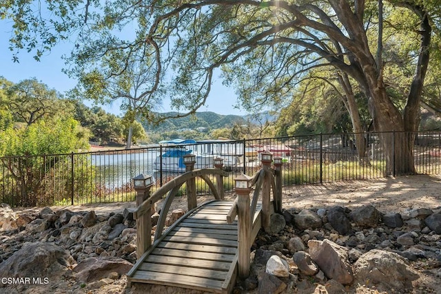 exterior space with a water and mountain view