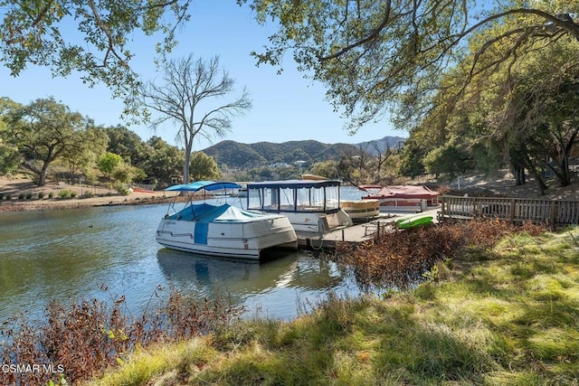 view of dock featuring a water and mountain view