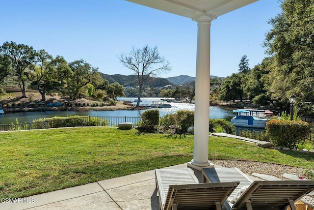 view of patio / terrace featuring a water and mountain view