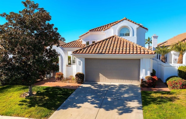 mediterranean / spanish-style home with a front yard and a garage