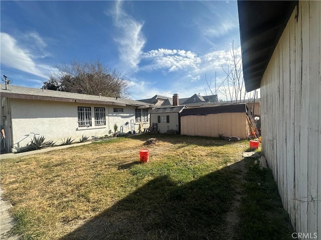 exterior space featuring a shed and a lawn