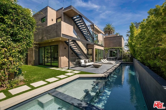 view of pool with a patio area and a yard