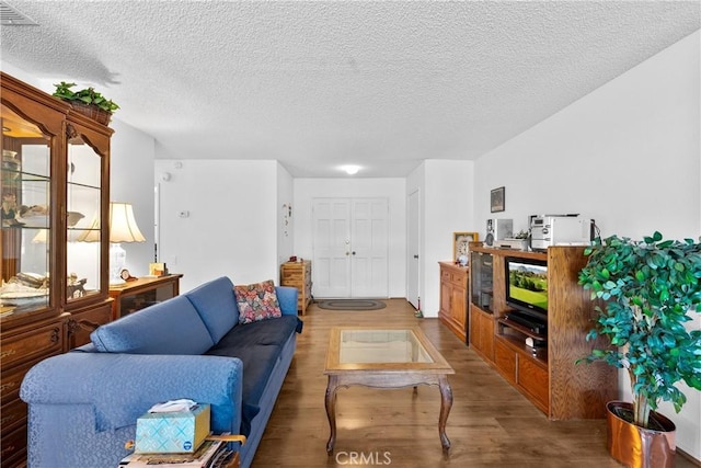 living room featuring hardwood / wood-style flooring and a textured ceiling