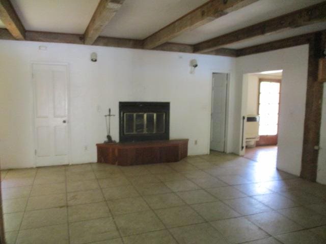 unfurnished living room featuring beam ceiling