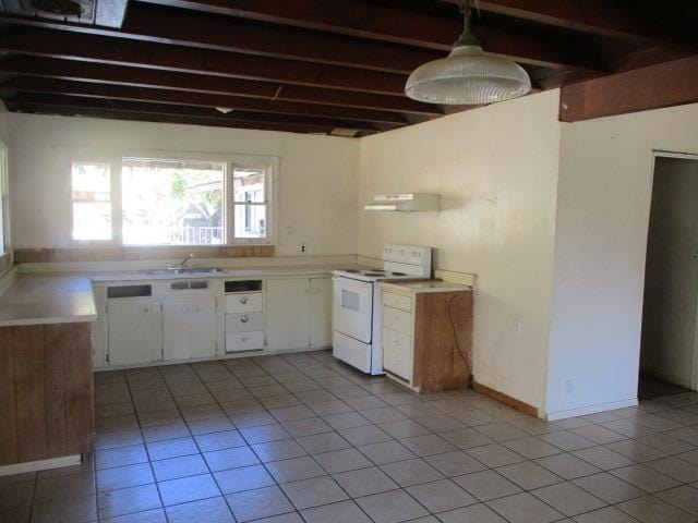 kitchen featuring light tile patterned floors, hanging light fixtures, beam ceiling, white cabinets, and white electric stove