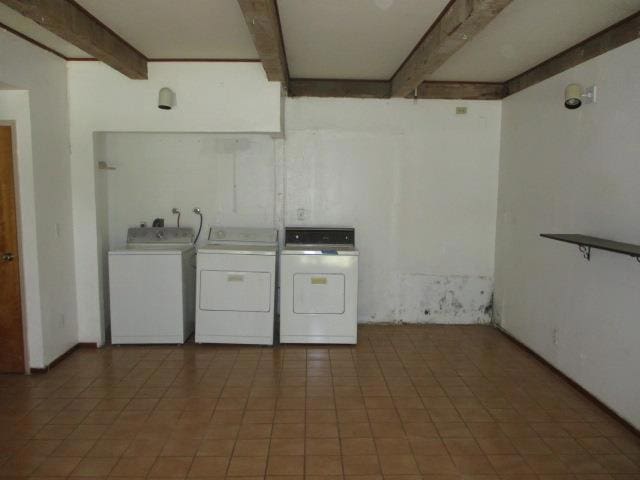 clothes washing area with independent washer and dryer