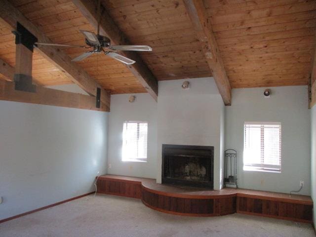 unfurnished living room with wood ceiling, carpet floors, and lofted ceiling with beams