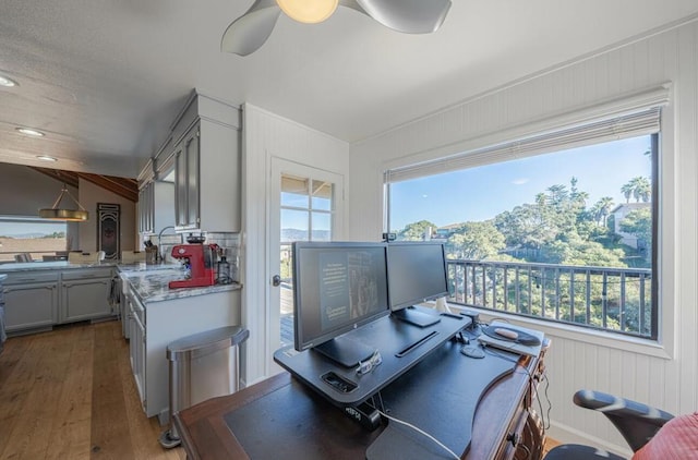 office space with dark wood-type flooring and ceiling fan