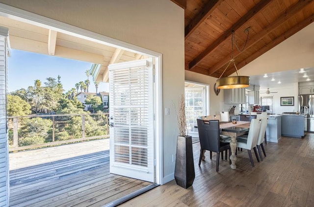 dining area featuring wood ceiling, lofted ceiling with beams, ceiling fan, and hardwood / wood-style flooring