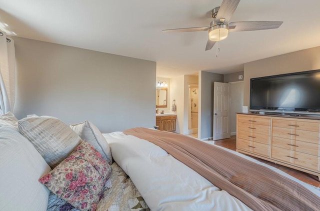 bedroom with wood-type flooring, connected bathroom, and ceiling fan