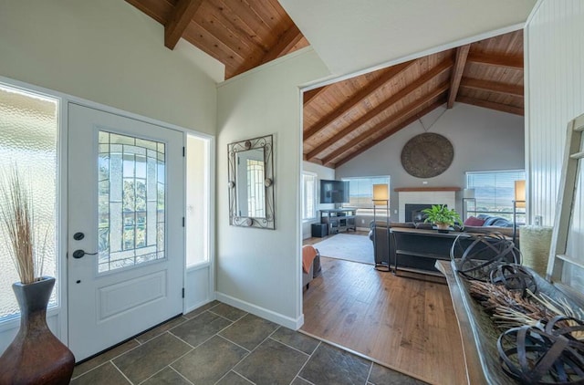 entrance foyer featuring beam ceiling, plenty of natural light, wooden ceiling, and high vaulted ceiling