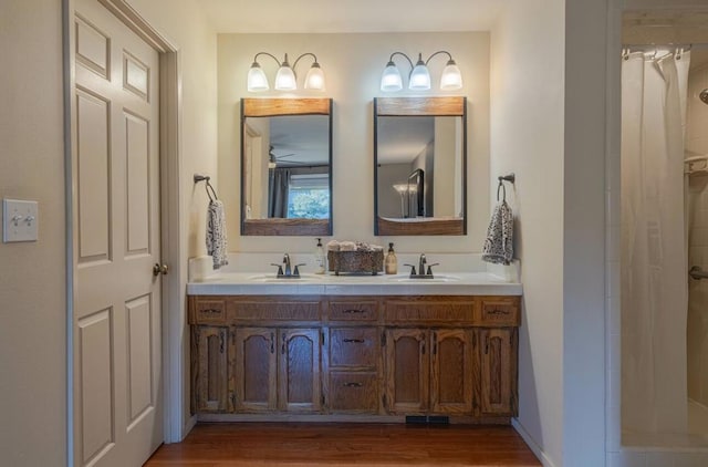 bathroom featuring vanity, hardwood / wood-style floors, ceiling fan, and walk in shower