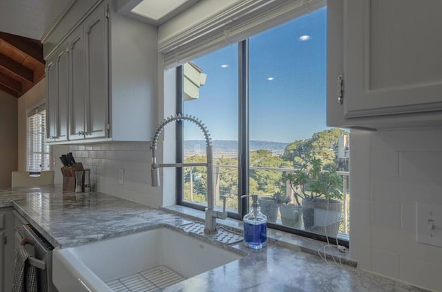 kitchen with plenty of natural light, sink, and backsplash