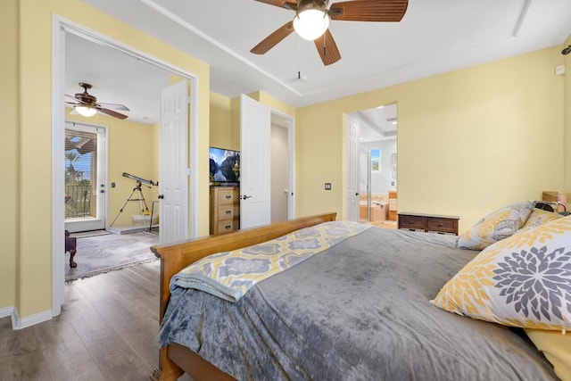 bedroom with ceiling fan, connected bathroom, and hardwood / wood-style flooring